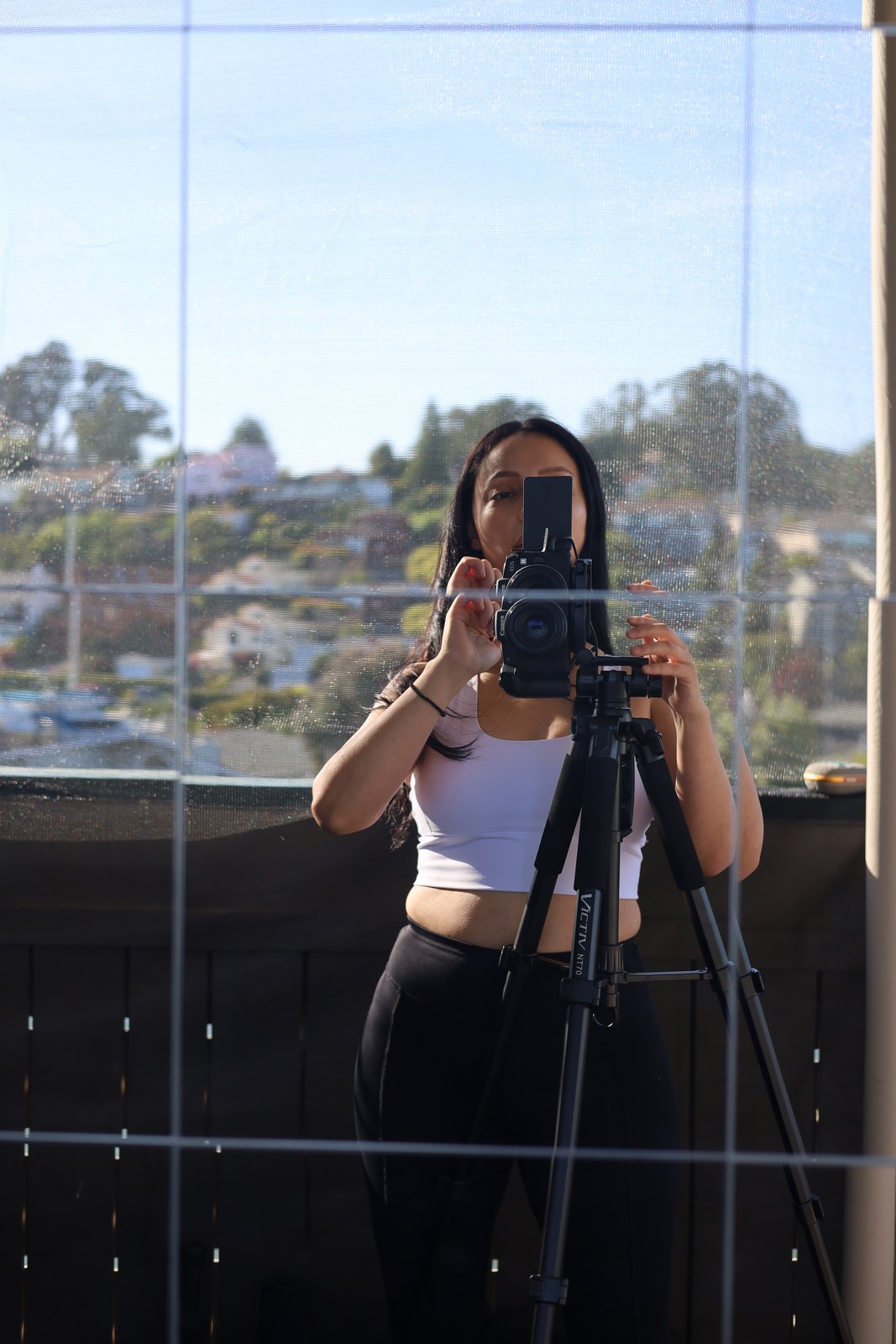 Angie with her camera on a tripod, ready to shoot